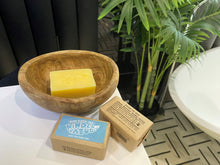 3 bars of Kinder by Nature Palm Oil-Free Shea Butter Baby Soap, one is in a wooden bowl