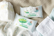 2 packs of Plant-Based Kinder by Nature Baby Wipes lying on a baby blanket